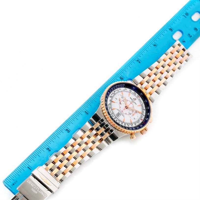 The image shows a Breitling Navitimer C23340 Men
s Steel and Gold (two tone) Silver Dial C23340 Men
s Steel and Gold (two tone) Silver Dial watch laid flat with a blue ruler for scale, displaying the watch face, band, and clasp.
