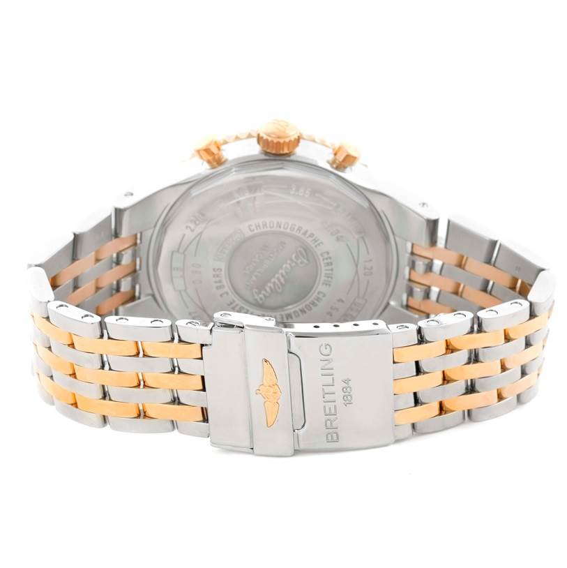 The image shows the back view of a Breitling Navitimer C23340 Men
s Steel and Gold (two tone) Silver Dial C23340 Men
s Steel and Gold (two tone) Silver Dial watch, highlighting its case back, crown, and two-tone bracelet with branding.