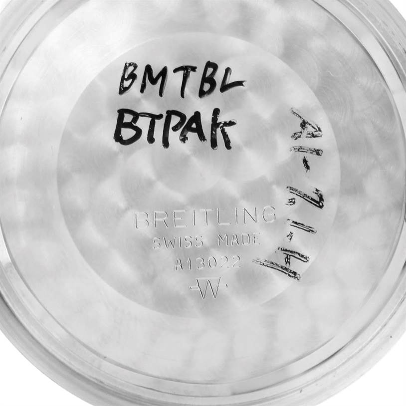 The image shows the inside case back of a Breitling Navitimer A13022 Men's Stainless Steel Blue Dial A13022 Men's Stainless Steel Blue Dial watch, featuring engraved text and handwritten notes.