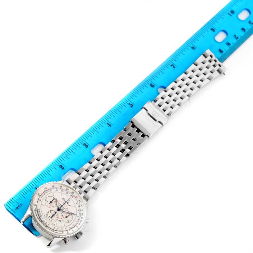 The Breitling Navitimer A41330 Men's Stainless Steel Silver Dial A41330 Men's Stainless Steel Silver Dial watch is displayed from a top-down angle, showing its face, bezel, and metal bracelet next to a ruler.