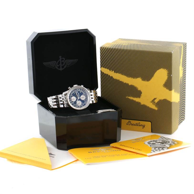 The image shows a Breitling Navitimer A13022 Men
s Stainless Steel Blue Dial A13022 Men
s Stainless Steel Blue Dial watch displayed at an angle inside its open box, alongside its packaging and manuals.