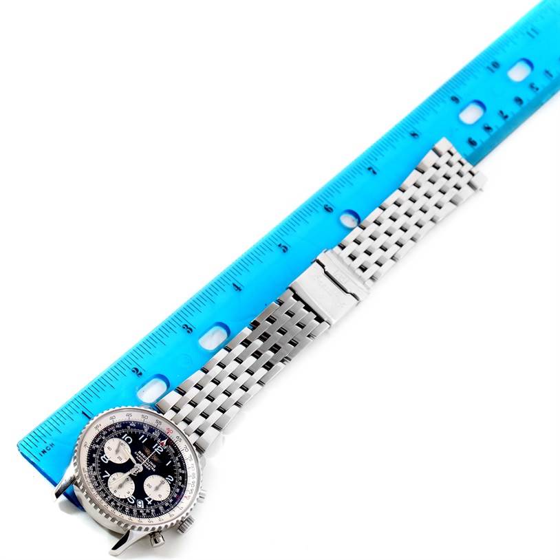 The image shows a Breitling Navitimer A23322 Men's Stainless Steel Black Dial A23322 Men's Stainless Steel Black Dial watch from a top-down angle with its bracelet extended beside a ruler.
