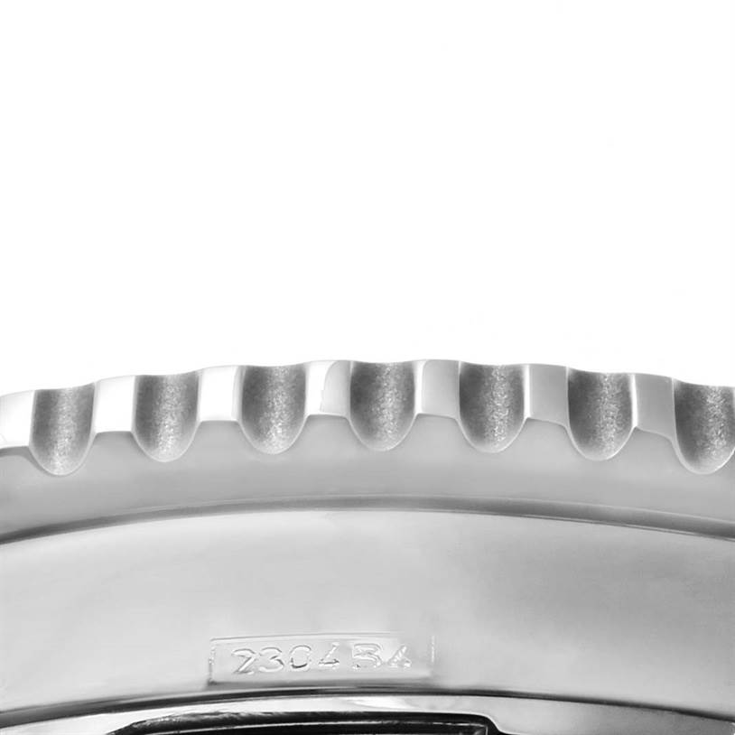 Close-up of the bezel and case side of the Breitling Navitimer A23322 Men's Stainless Steel Black Dial A23322 Men's Stainless Steel Black Dial watch, showing the serrated bezel edge and engraved serial number.