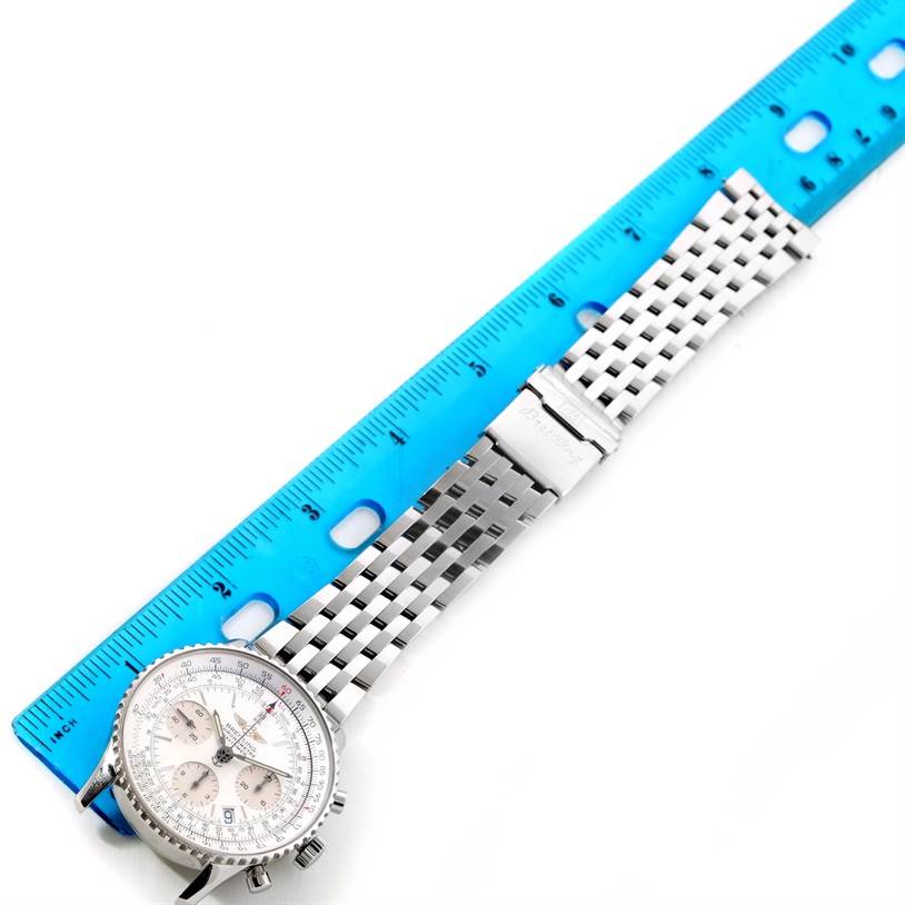 The Breitling Navitimer A23322 Men's Stainless Steel Silver Dial A23322 Men's Stainless Steel Silver Dial watch is shown flat with the face, bracelet, and clasp visible, alongside a blue ruler for scale.