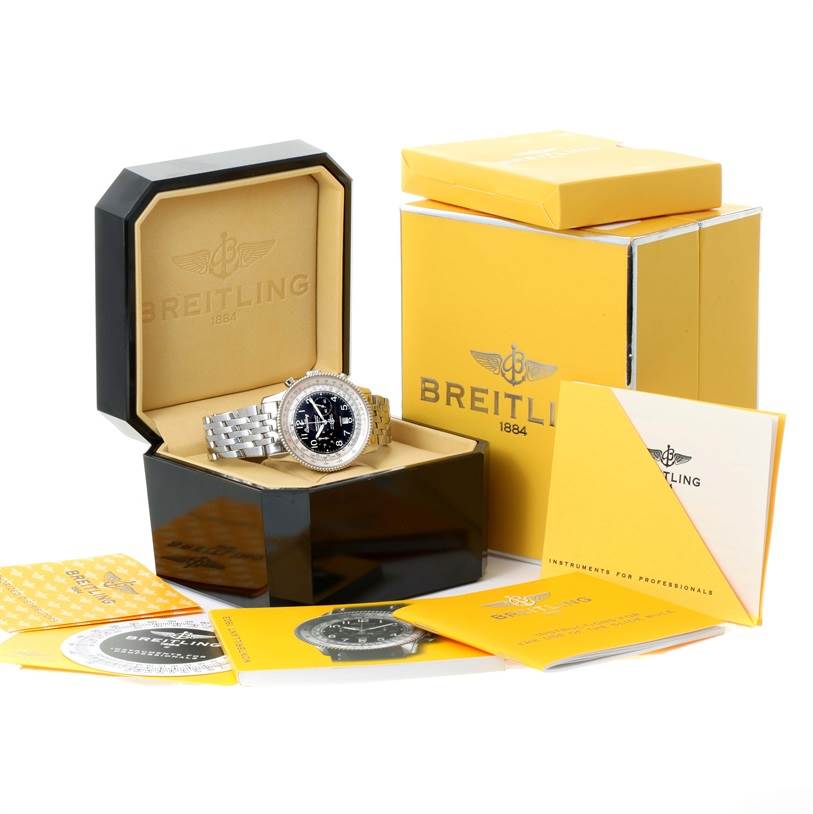 The image shows a Breitling Navitimer A35330 Men's Stainless Steel Black Dial A35330 Men's Stainless Steel Black Dial watch displayed at an angle alongside its box, packaging, and accompanying documents.