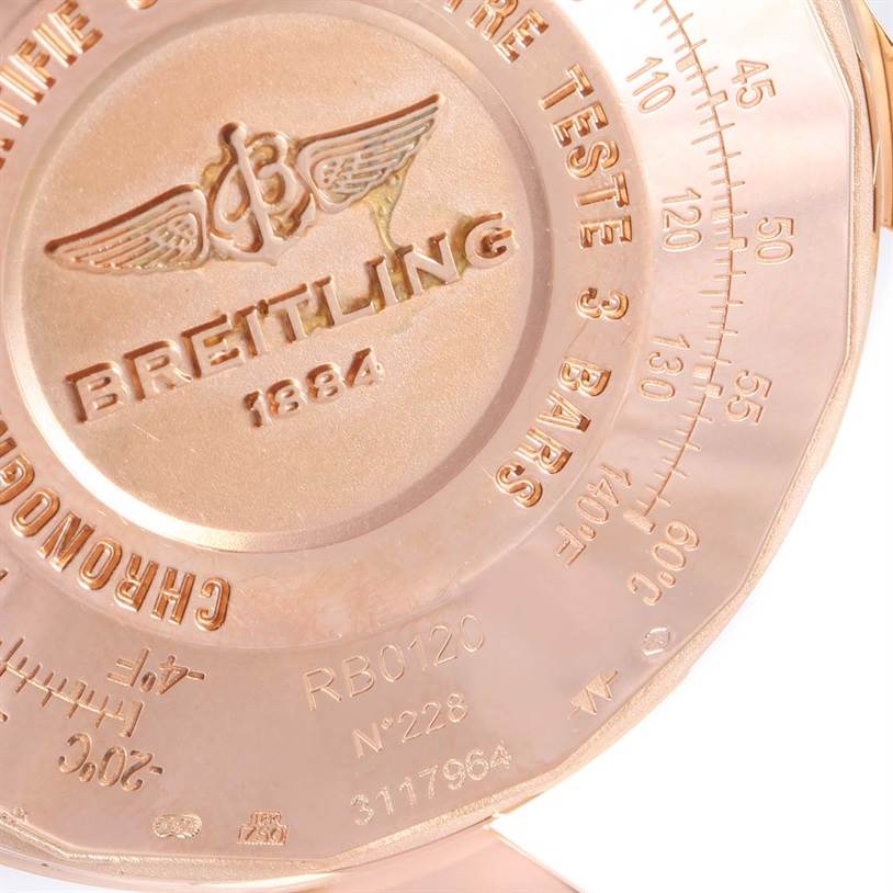 The image shows the case back of a Breitling Navitimer RB0120 Men's Rose Gold Black Dial RB0120 Men's Rose Gold Black Dial watch with engravings and a logo.