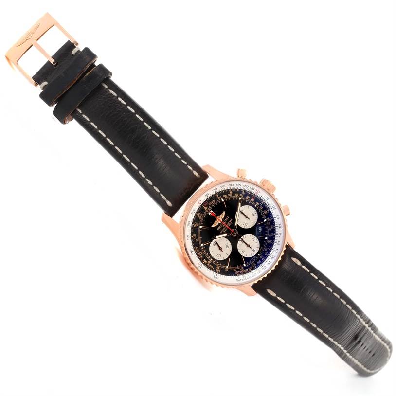 The Breitling Navitimer RB0120 Men's Rose Gold Black Dial RB0120 Men's Rose Gold Black Dial watch is shown from a top-down angle, displaying its black dial, subdials, and leather strap with stitching.