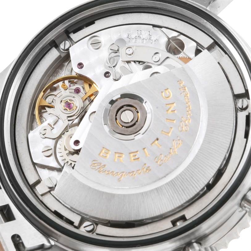 The image shows the rear view of a Breitling Navitimer A13330 Men
s Stainless Steel Silver Dial A13330 Men
s Stainless Steel Silver Dial watch, focusing on its intricate mechanical movement and rotor.