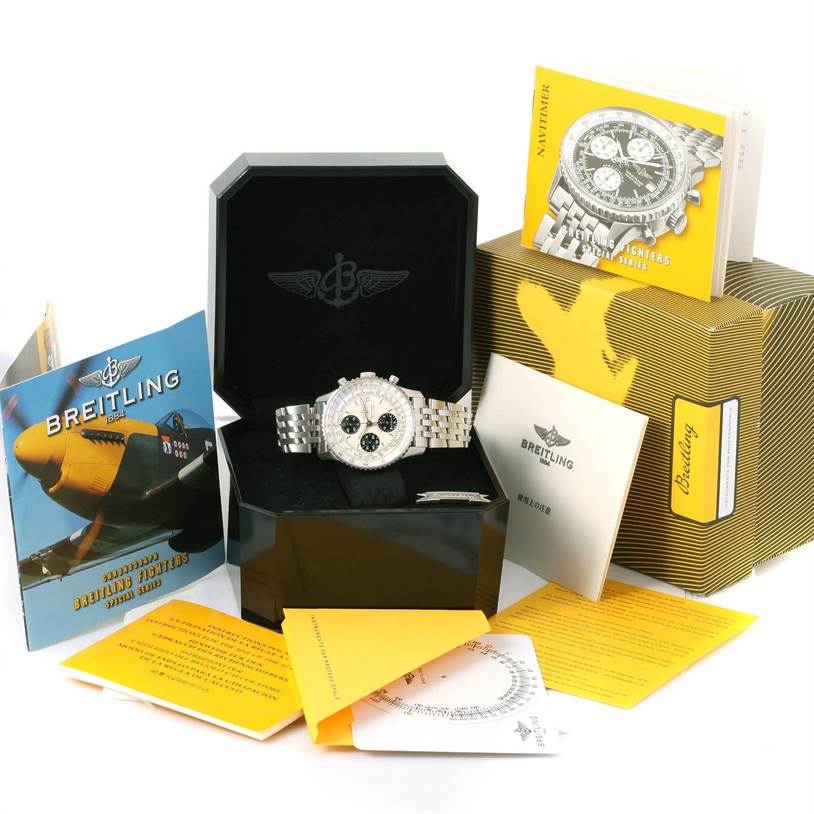 The Navitimer by Breitling is shown in its box with accompanying manuals and packaging from a frontal angle.