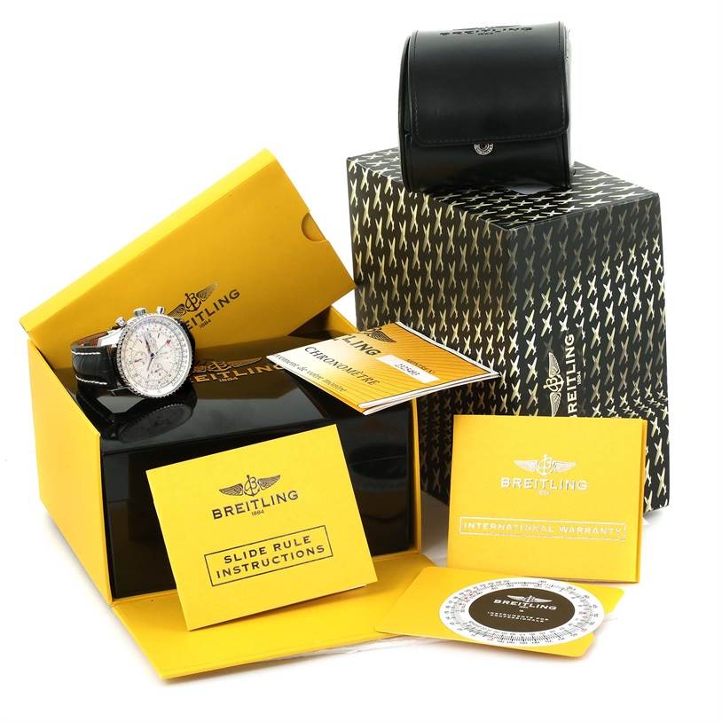 This image shows a Breitling Navitimer A24322 Men
s Stainless Steel Silver Dial A24322 Men
s Stainless Steel Silver Dial watch with its box, manuals, and accessories from an angled top view.