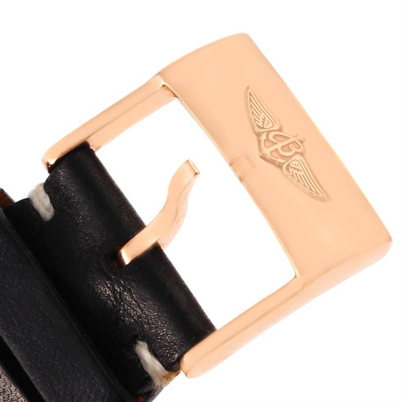 This image shows a close-up of the gold buckle on a leather strap for a Breitling Navitimer RB0120 Men's Rose Gold Black Dial RB0120 Men's Rose Gold Black Dial watch.