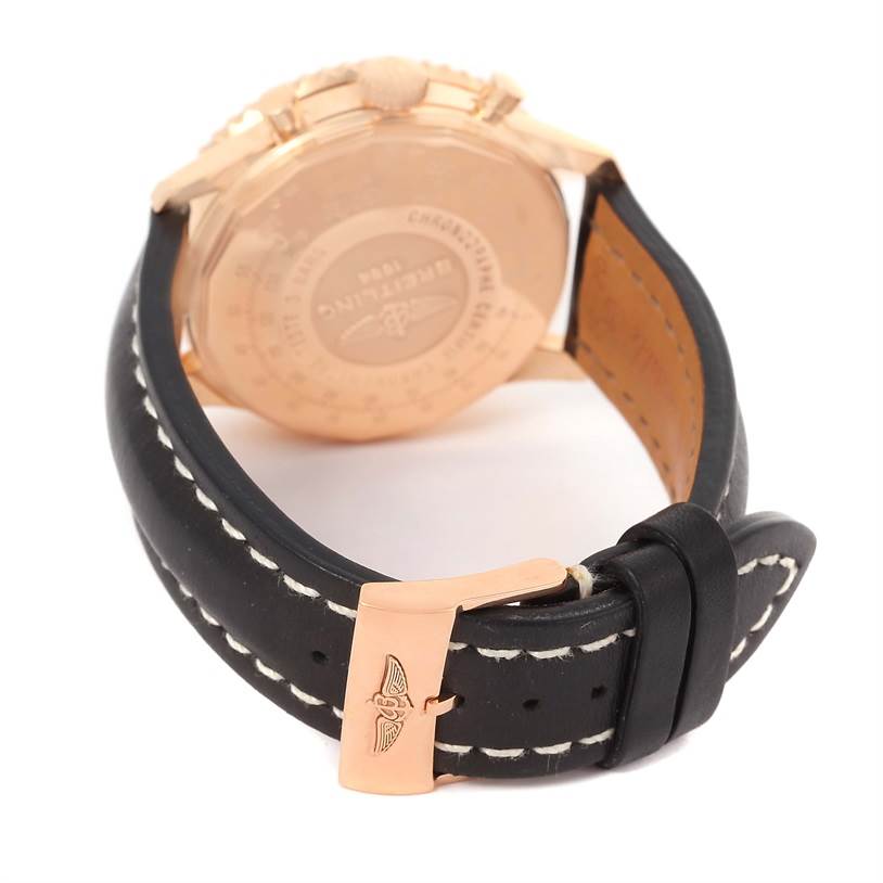 The image shows the back of a Breitling Navitimer RB0120 Men's Rose Gold Black Dial RB0120 Men's Rose Gold Black Dial watch with a black leather strap and rose gold buckle.
