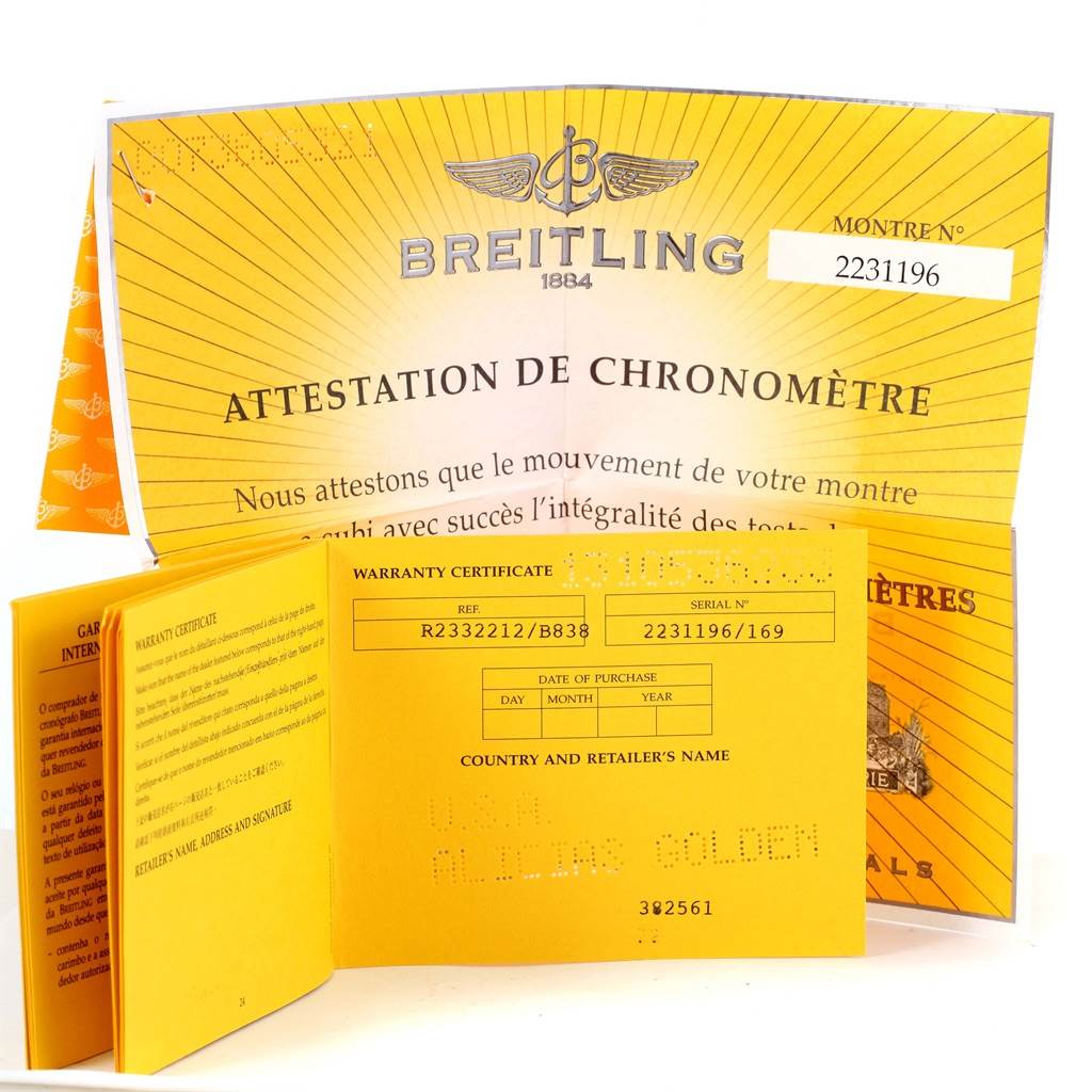 The image shows warranty certificates and chronometer attestation for the Breitling Navitimer R23322 Men's Rose Gold Black Dial R23322 Men's Rose Gold Black Dial model.