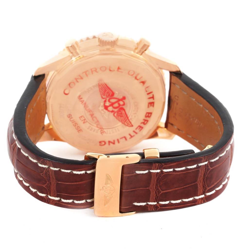 The image shows the rear view of a Breitling Navitimer R24322 Men's Rose Gold Black Dial R24322 Men's Rose Gold Black Dial watch, highlighting the case back and brown leather strap with a buckle.