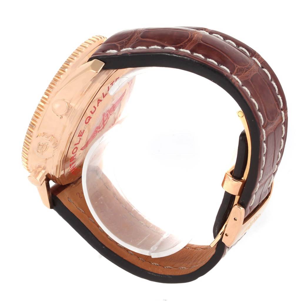 This side view of the Breitling Navitimer R24322 Men's Rose Gold Black Dial R24322 Men's Rose Gold Black Dial watch shows its case, crown, and leather strap with stitching.