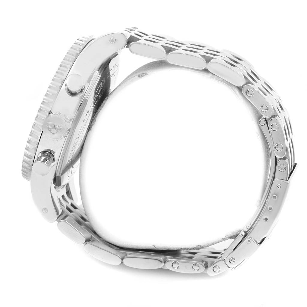 The image shows a side angle of the Breitling Navitimer A23340 Men
s Stainless Steel Brown Dial A23340 Men
s Stainless Steel Brown Dial watch, highlighting the case, crown, pushers, and the metal bracelet.