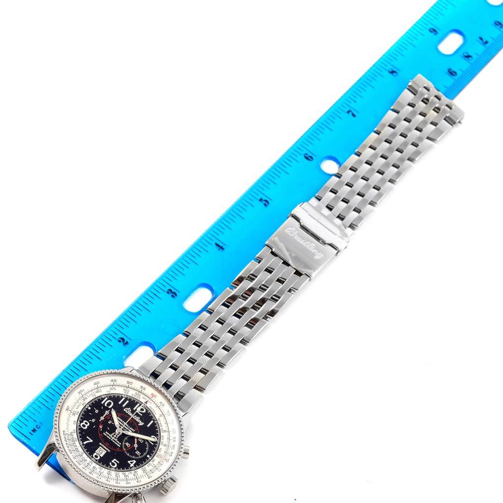 The image shows a top-down view of a Breitling Navitimer A35330 Men
s Stainless Steel Black Dial A35330 Men
s Stainless Steel Black Dial watch with its metal bracelet and a blue ruler for scale.