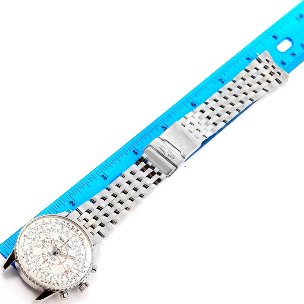 The image shows a Breitling Navitimer A21330 Men's Stainless Steel Silver Dial A21330 Men's Stainless Steel Silver Dial watch laid flat, with the stainless steel bracelet and clasp visible alongside a blue ruler.