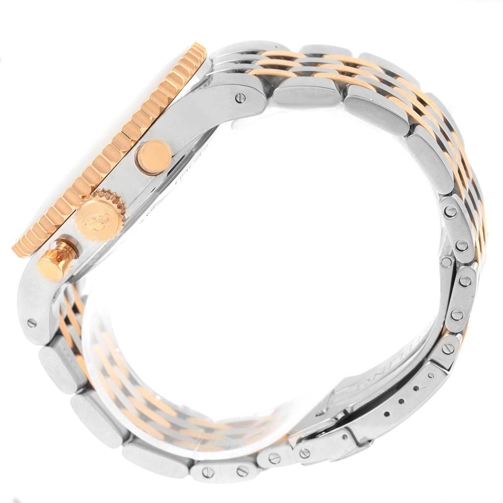 The image shows a side view of the Breitling Navitimer C23340 Men
s Steel and Gold (two tone) Black Dial C23340 Men
s Steel and Gold (two tone) Black Dial watch, highlighting its crown, pushers, and two-tone bracelet.