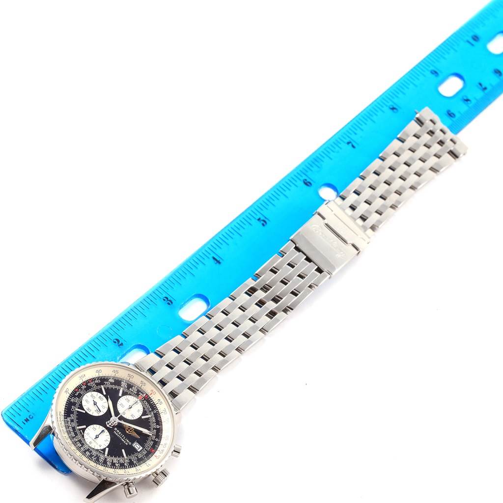 The Breitling Navitimer A13322 Men's Stainless Steel Black Dial A13322 Men's Stainless Steel Black Dial watch is shown laying flat, with the stainless steel bracelet and dial visible, measured against a blue ruler.