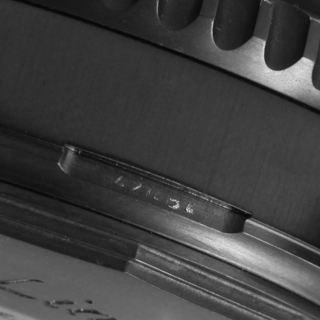 The image shows a close-up of the bezel and edge of the case of a Breitling Navitimer M19380 Men's Stainless Steel Black Dial M19380 Men's Stainless Steel Black Dial watch.