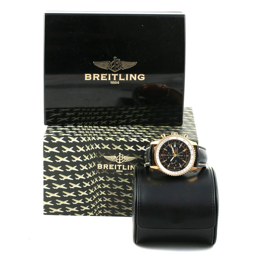 The image shows a Breitling Navitimer K24322 Men's Yellow Gold Black Dial K24322 Men's Yellow Gold Black Dial watch with a front view, along with its branded box and presentation case.