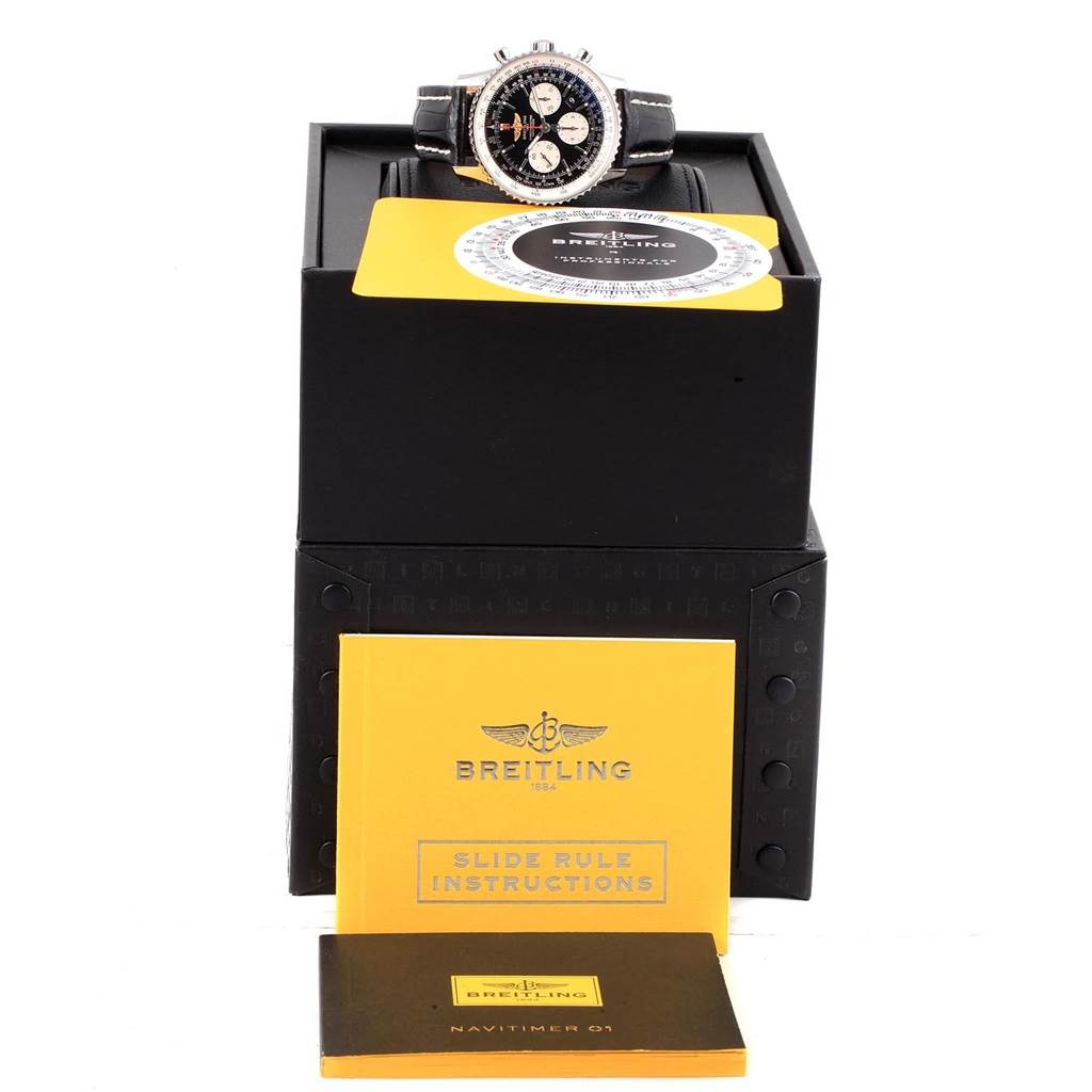 The image shows a Breitling Navitimer AB0120 Men
s Stainless Steel Black Dial AB0120 Men
s Stainless Steel Black Dial watch from a front angle, along with its box, slide rule instructions, and warranty booklet.