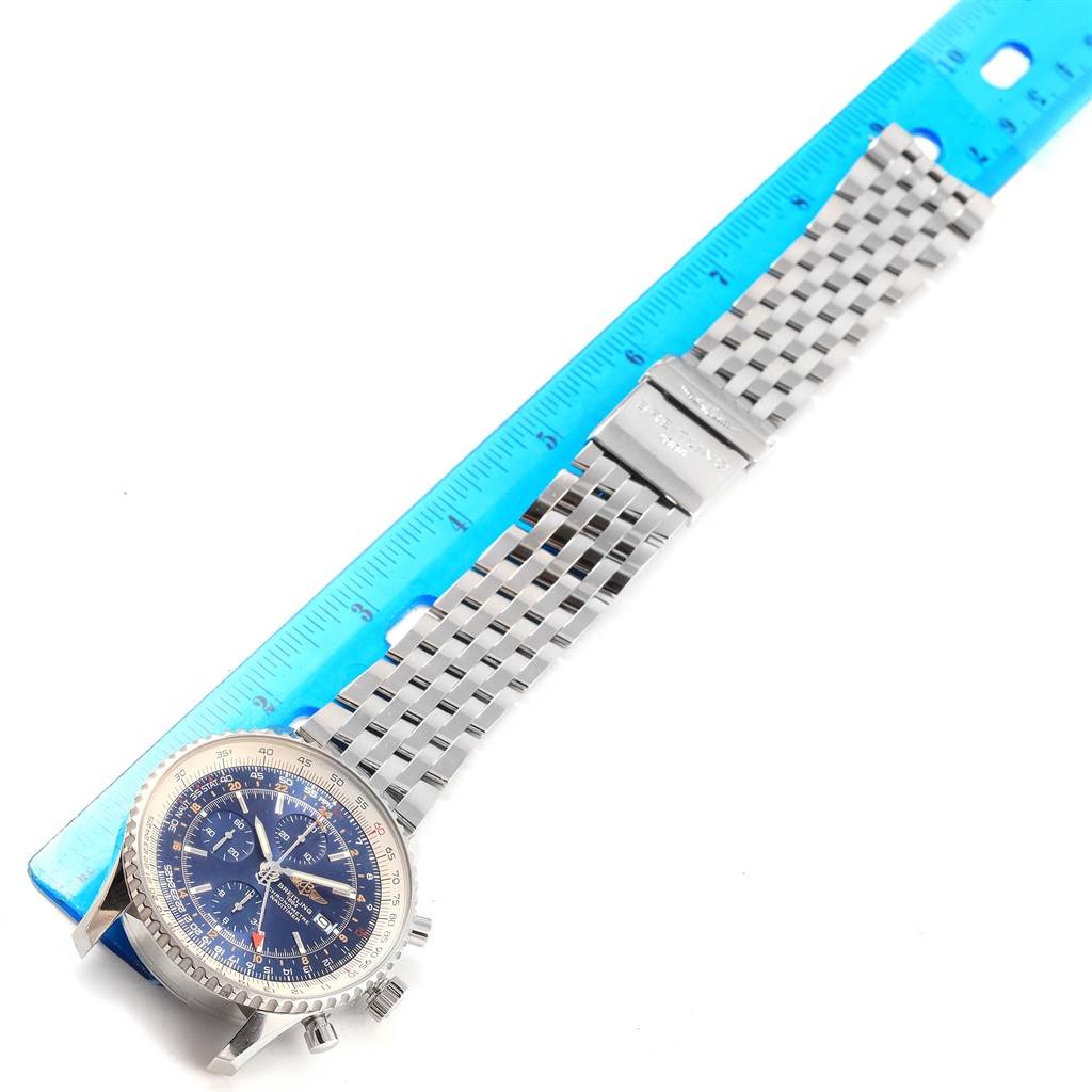 The image shows a Breitling Navitimer A24322 Men
s Stainless Steel Blue Dial A24322 Men
s Stainless Steel Blue Dial watch laid flat with its metal bracelet next to a blue ruler, viewed from above.