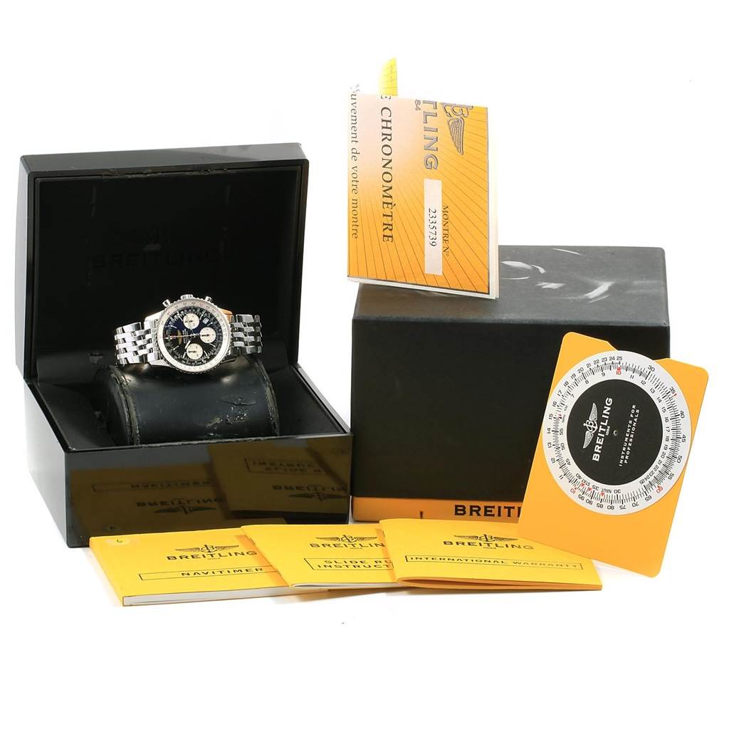 The Navitimer by Breitling is shown from a front angle with its box, manual, and other accessories.