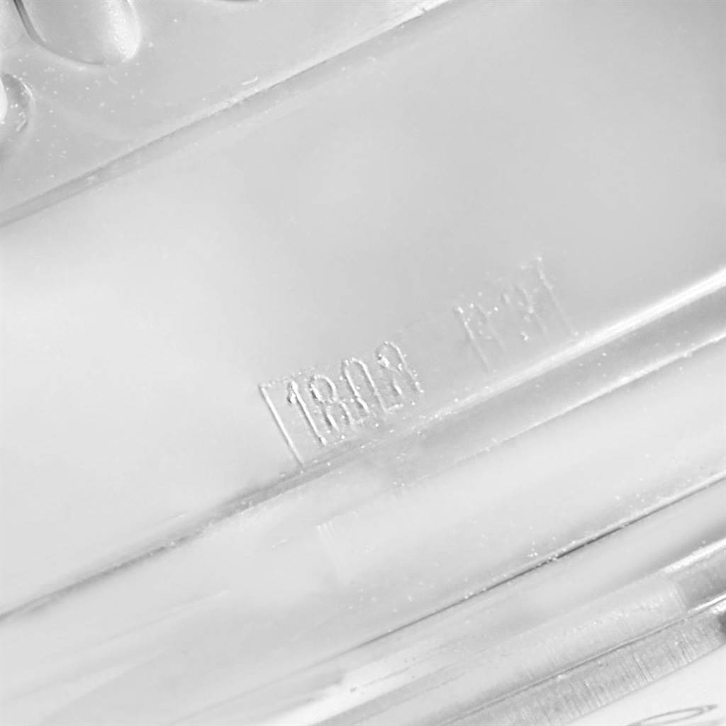 The image shows a close-up of the side of the case for a Breitling Navitimer A23322 Men's Stainless Steel Silver Dial A23322 Men's Stainless Steel Silver Dial model watch, including the serial number.