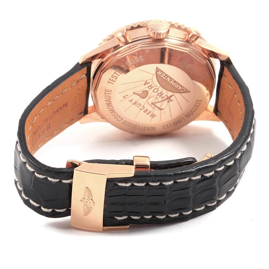 The image shows the back case and black leather strap with a gold clasp of the Breitling Navitimer RB0210 Men's Rose Gold Black Dial RB0210 Men's Rose Gold Black Dial watch at an angle.