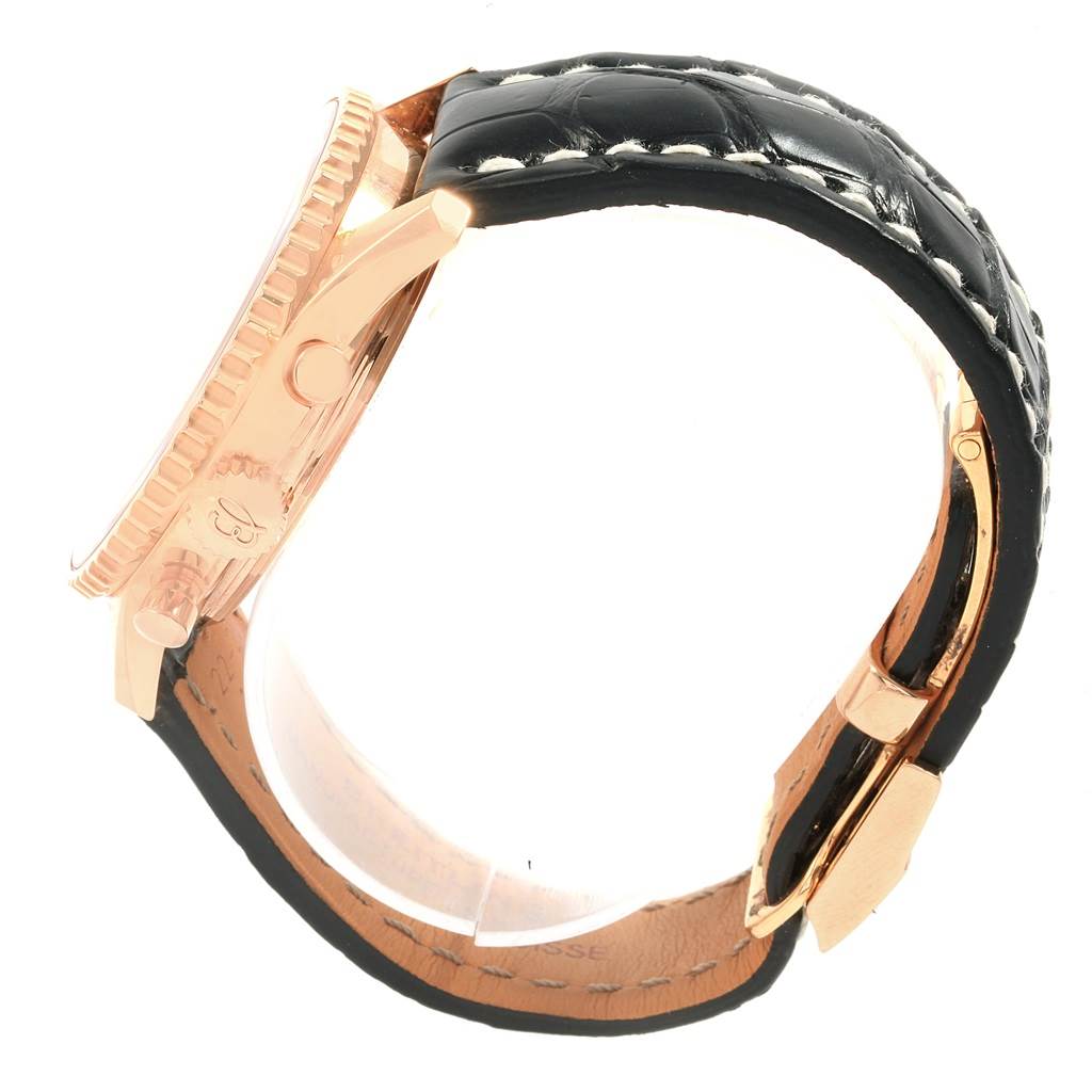 The image shows a side view of a Breitling Navitimer RB0210 Men's Rose Gold Black Dial RB0210 Men's Rose Gold Black Dial watch, highlighting its crown, pushers, and black leather strap.