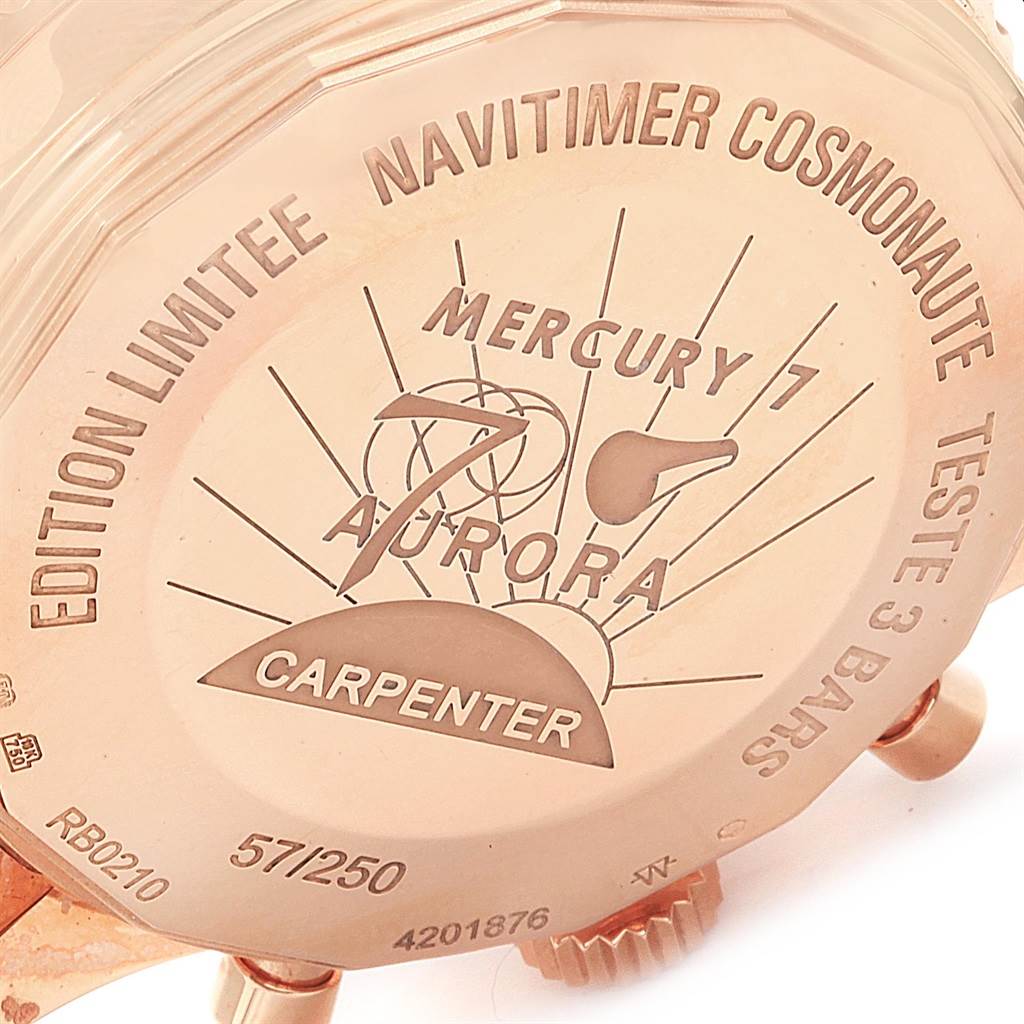 The image shows the case back of a Breitling Navitimer RB0210 Men's Rose Gold Black Dial RB0210 Men's Rose Gold Black Dial Cosmonaute watch, featuring engraved details and numbering.