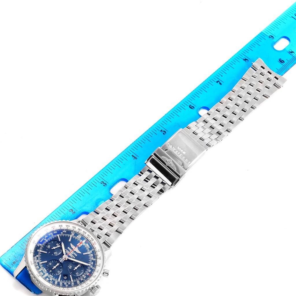 The Breitling Navitimer AB0125 Men's Stainless Steel Blue Dial AB0125 Men's Stainless Steel Blue Dial watch is shown from a top-down angle, displaying its face and metal bracelet alongside a ruler.