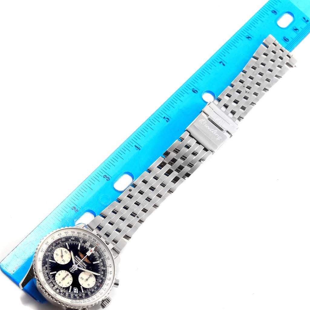 The image shows a Breitling Navitimer A23322 Men's Stainless Steel Silver Dial A23322 Men's Stainless Steel Silver Dial watch face and stainless steel bracelet with a blue ruler for scale.