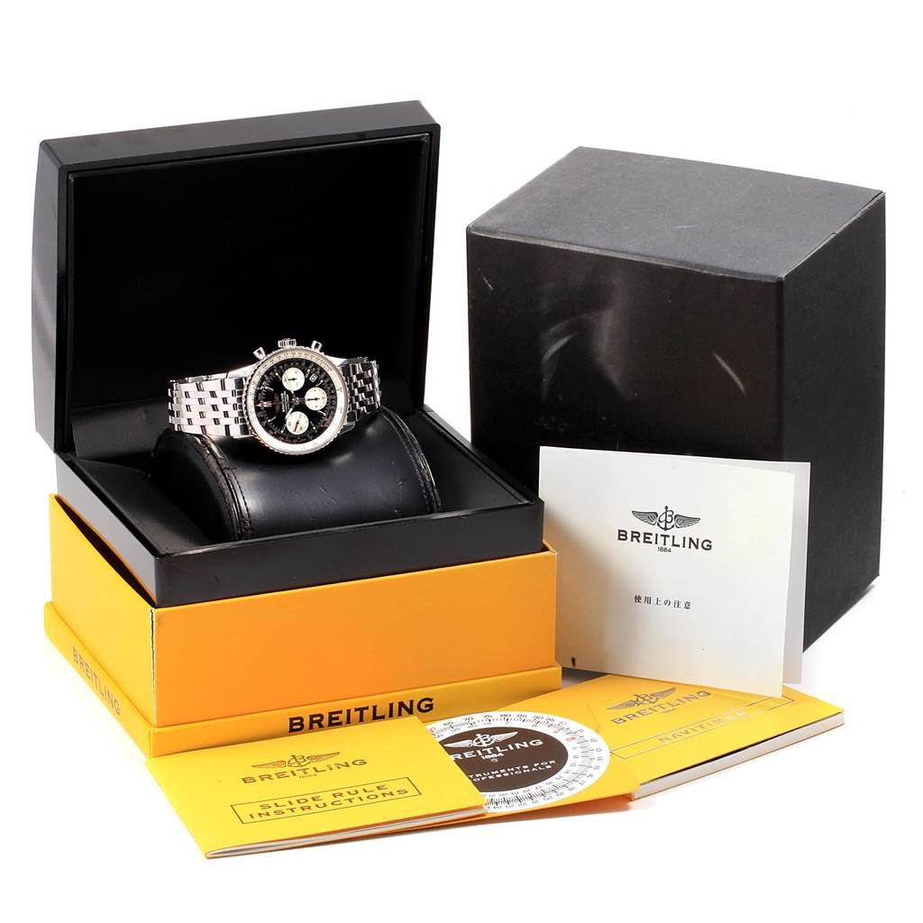 The Breitling Navitimer A23322 Men's Stainless Steel Silver Dial A23322 Men's Stainless Steel Silver Dial watch is shown in its open box along with manuals, a circular slide rule, and additional packaging.