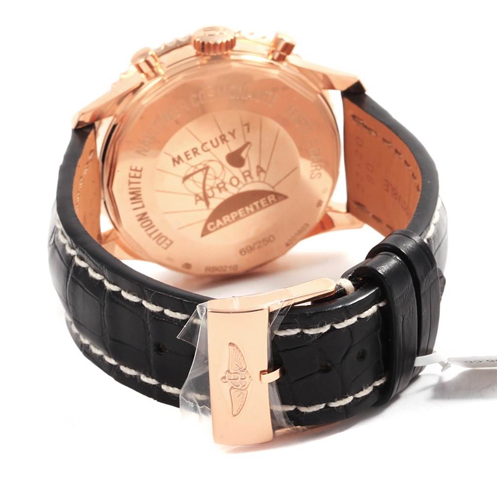 The image shows the back and part of the strap of a Breitling Navitimer RB0210 Men's Rose Gold Black Dial RB0210 Men's Rose Gold Black Dial watch, highlighting its buckle and engraved case back.