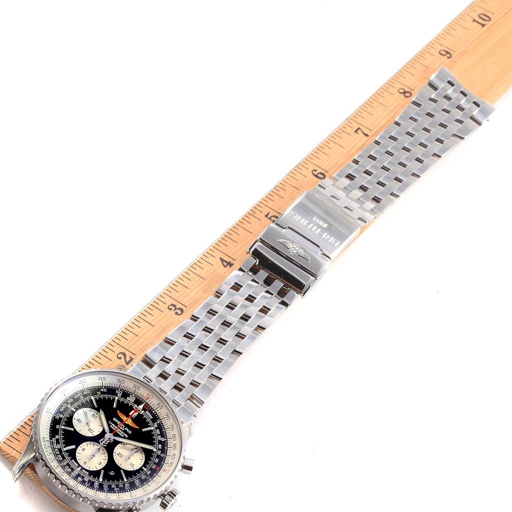 The image shows a Breitling Navitimer AB012721-BD09SS Men
s Stainless Steel Black Dial AB012721-BD09SS Men
s Stainless Steel Black Dial watch laid flat with a metal bracelet, alongside a ruler for measurement.