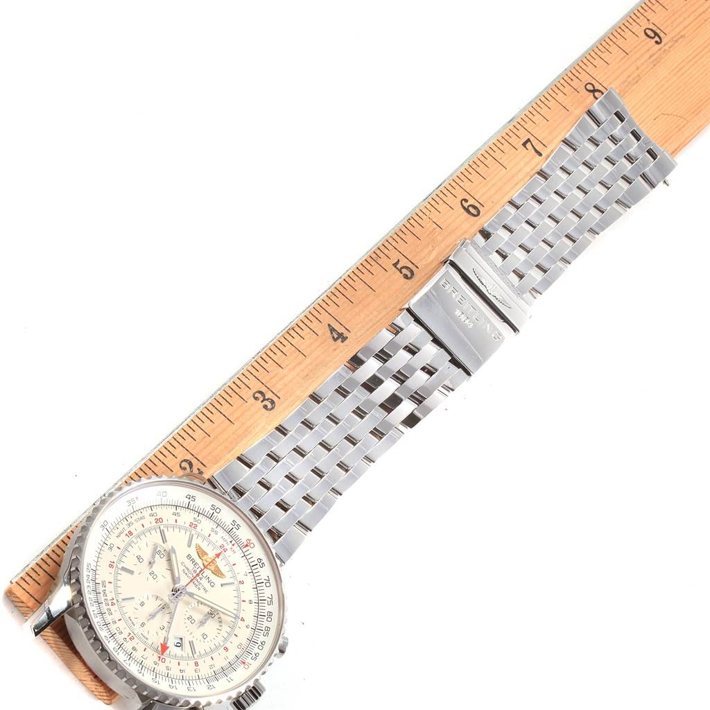 The Breitling Navitimer AB044121-G783-453A Men
s Stainless Steel Silver Dial AB044121-G783-453A Men
s Stainless Steel Silver Dial watch is shown from a top-down angle, displaying its face, bezel, and metal bracelet beside a ruler.