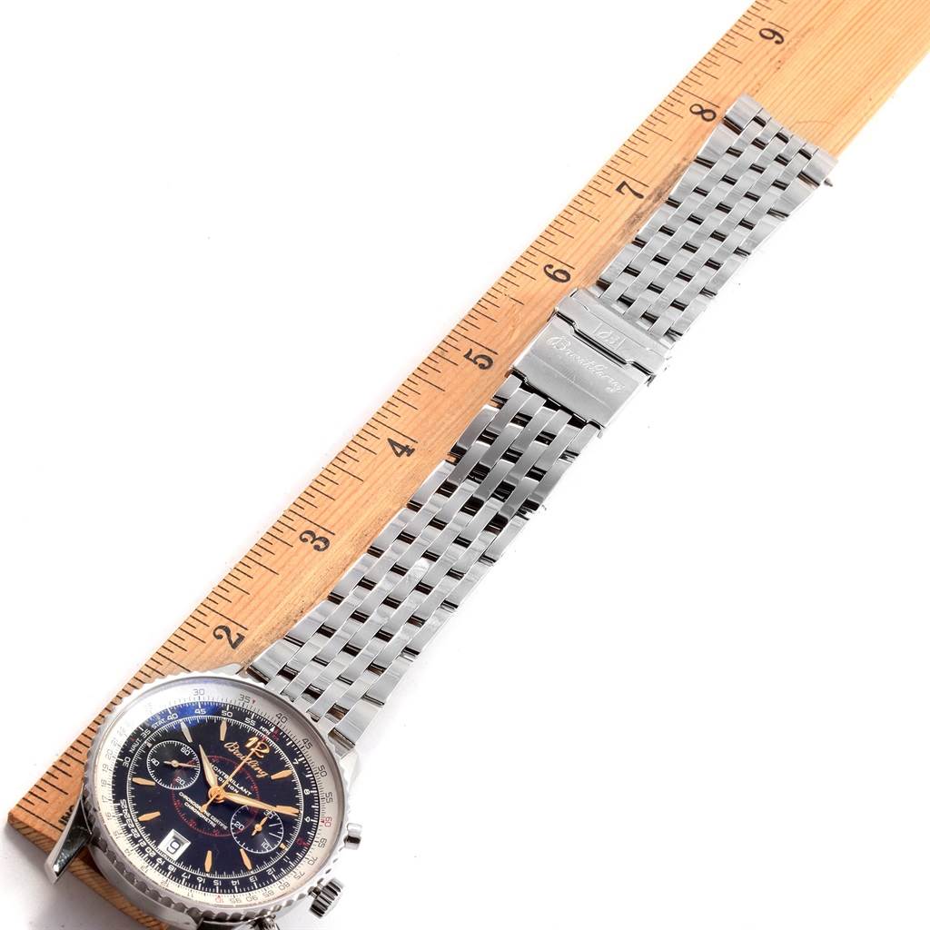 The image shows the face and bracelet of a Breitling Navitimer A48330 Men
s Stainless Steel Black Dial A48330 Men
s Stainless Steel Black Dial watch aligned with a ruler for measurement.
