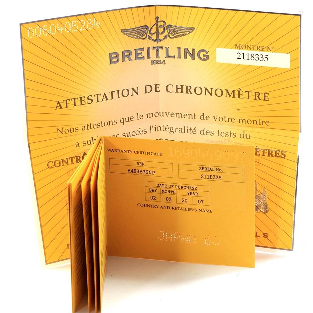 The image shows a Breitling Navitimer A48330 Men
s Stainless Steel Black Dial A48330 Men
s Stainless Steel Black Dial
s warranty certificate and chronometer attestation documents.