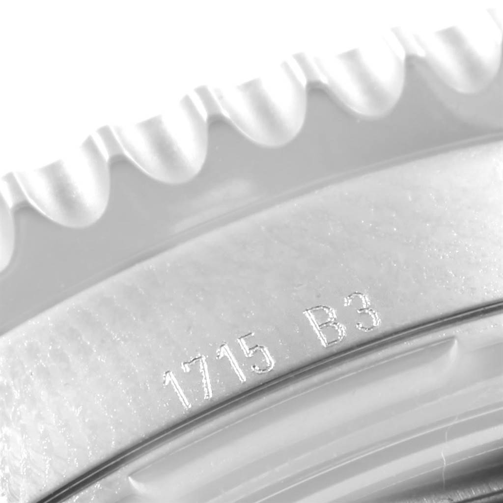 This is a close-up image of the bezel and case details of a Breitling Navitimer AB012721-BD09-453A Men's Stainless Steel Black Dial AB012721-BD09-453A Men's Stainless Steel Black Dial watch, showing part of its engravings.