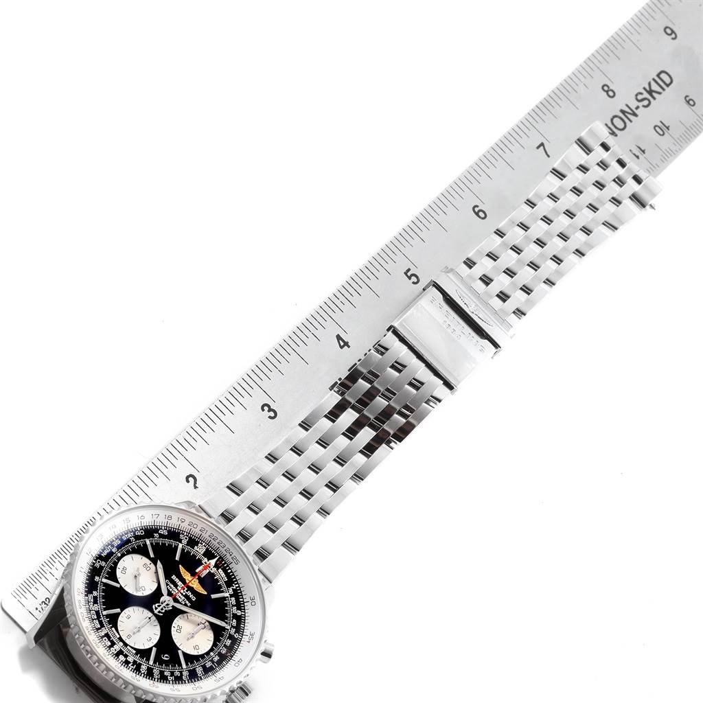 The image shows the face and metal bracelet of a Breitling Navitimer AB012721-BD09-453A Men
s Stainless Steel Black Dial AB012721-BD09-453A Men
s Stainless Steel Black Dial watch alongside a ruler.