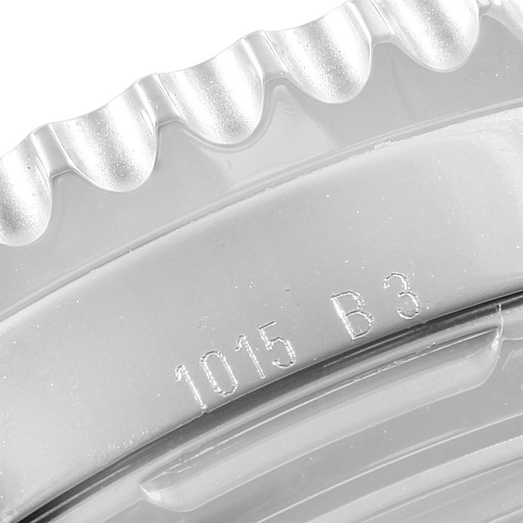 The image shows a close-up angle of the bezel and case edge of a Breitling Navitimer AB012721-BD09-453A Men
s Stainless Steel Black Dial AB012721-BD09-453A Men
s Stainless Steel Black Dial, with some engraved markings visible.