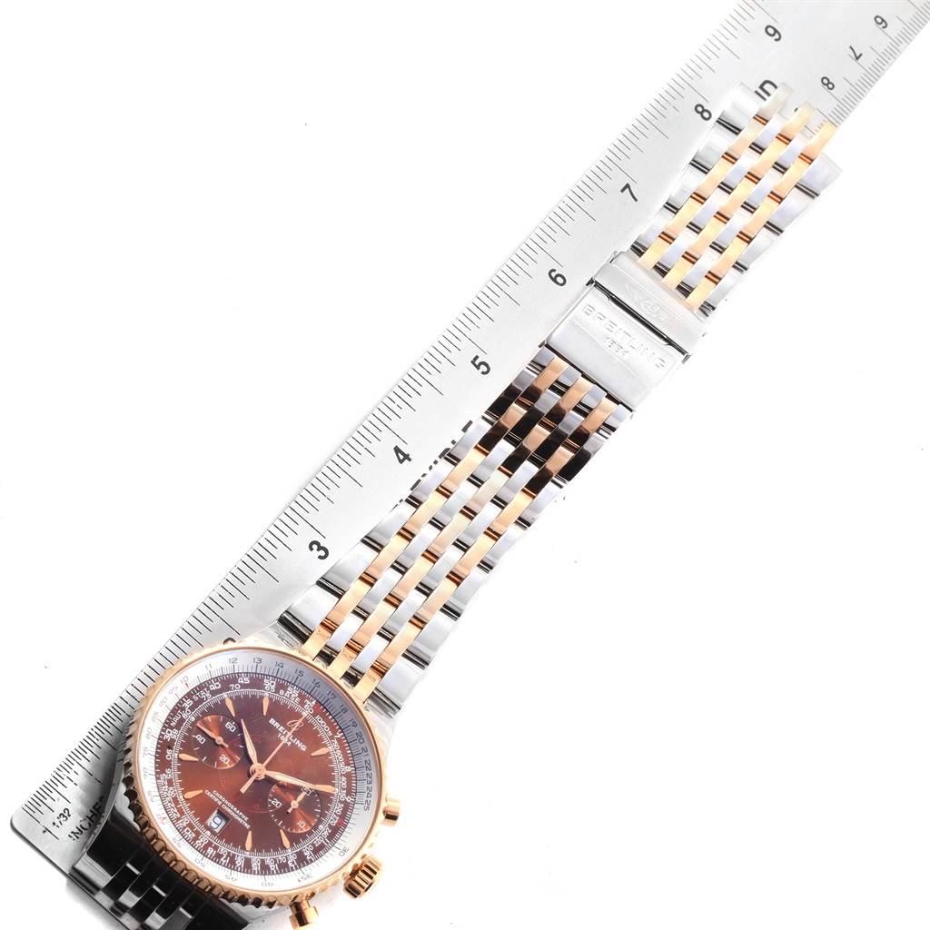 The image shows a Breitling Navitimer C23340 Men's Steel and Gold (two tone) Brown Dial C23340 Men's Steel and Gold (two tone) Brown Dial watch face-up alongside a ruler, highlighting the watch's case and bracelet.