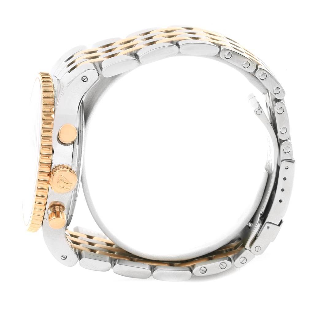 This side view of the Breitling Navitimer C23340 Men's Steel and Gold (two tone) Brown Dial C23340 Men's Steel and Gold (two tone) Brown Dial watch shows the crown, chronograph pushers, and the two-tone bracelet.