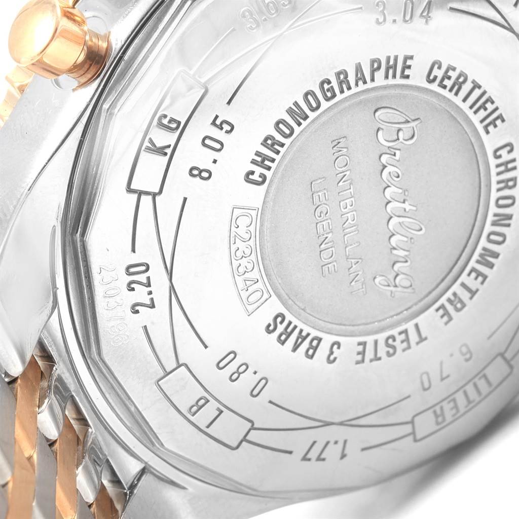 This image shows the back case engraving and part of the bracelet of the Breitling Navitimer C23340 Men's Steel and Gold (two tone) Brown Dial C23340 Men's Steel and Gold (two tone) Brown Dial watch model.