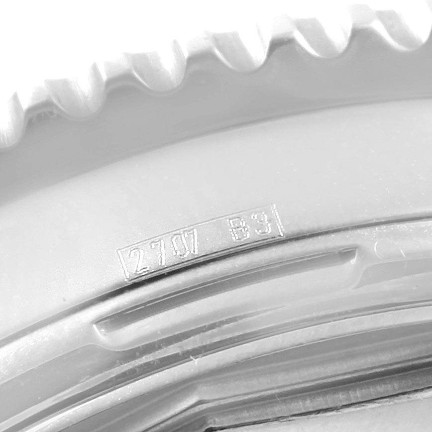 The image shows a close-up of the serrated bezel and case edge of a Breitling Navitimer A23322 Men's Stainless Steel Black Dial A23322 Men's Stainless Steel Black Dial watch.