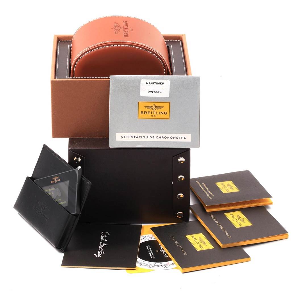 The image shows a Breitling Navitimer A13324 Men's Stainless Steel Silver Dial A13324 Men's Stainless Steel Silver Dial watch box with its accessories, manuals, and a warranty card from a frontal angle.