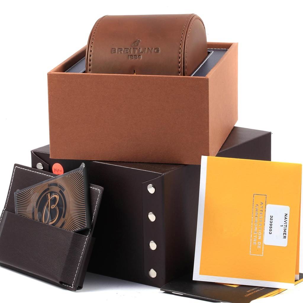 The image shows a Breitling Navitimer AB0127211C1A1 Men's Stainless Steel Blue Dial AB0127211C1A1 Men's Stainless Steel Blue Dial watch box set, including a brown leather case, documentation, and additional packaging materials.